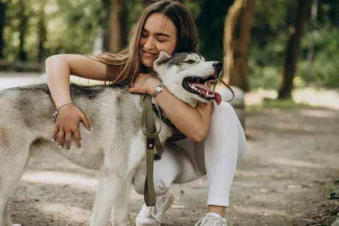 Woman hugging a Husky